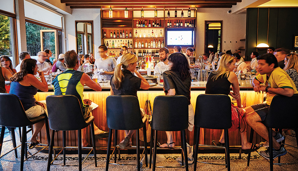 Patrons chat at the bar at the Coda di Volpe restaurant in Chicago