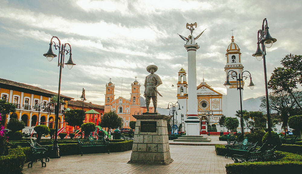 A statue stands in Puebla, Mexico, surrounded by stunning architecture