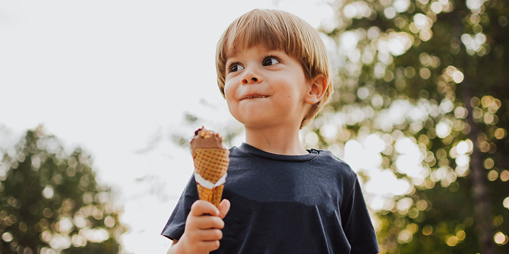 A young boy enjoys an ice cream cone