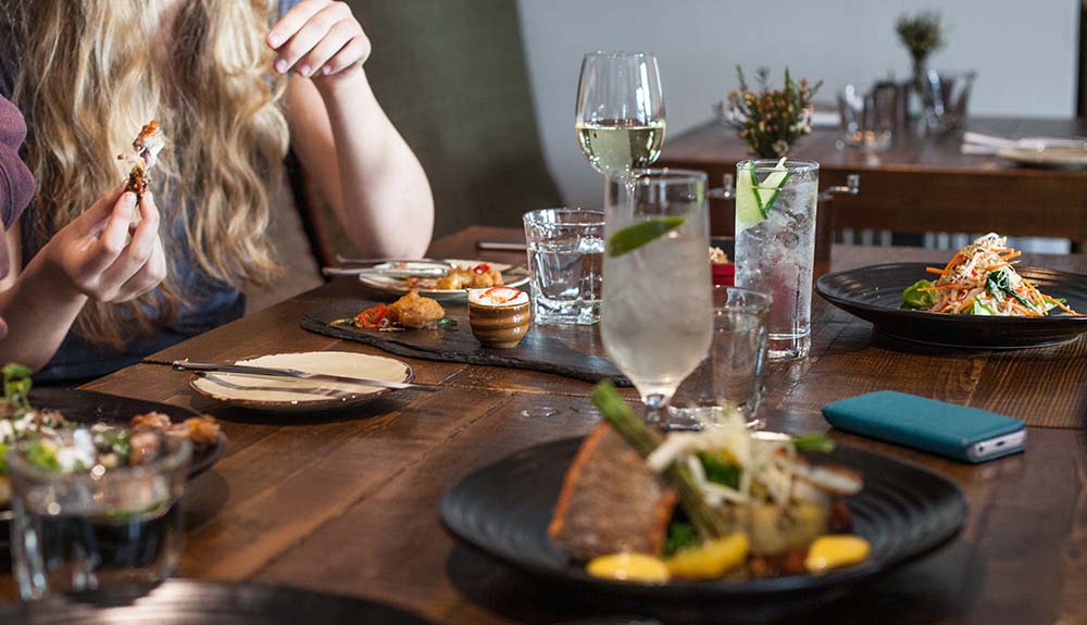 A woman eats lunch at the Dulse & Brose restaurant in Portree, Scotland