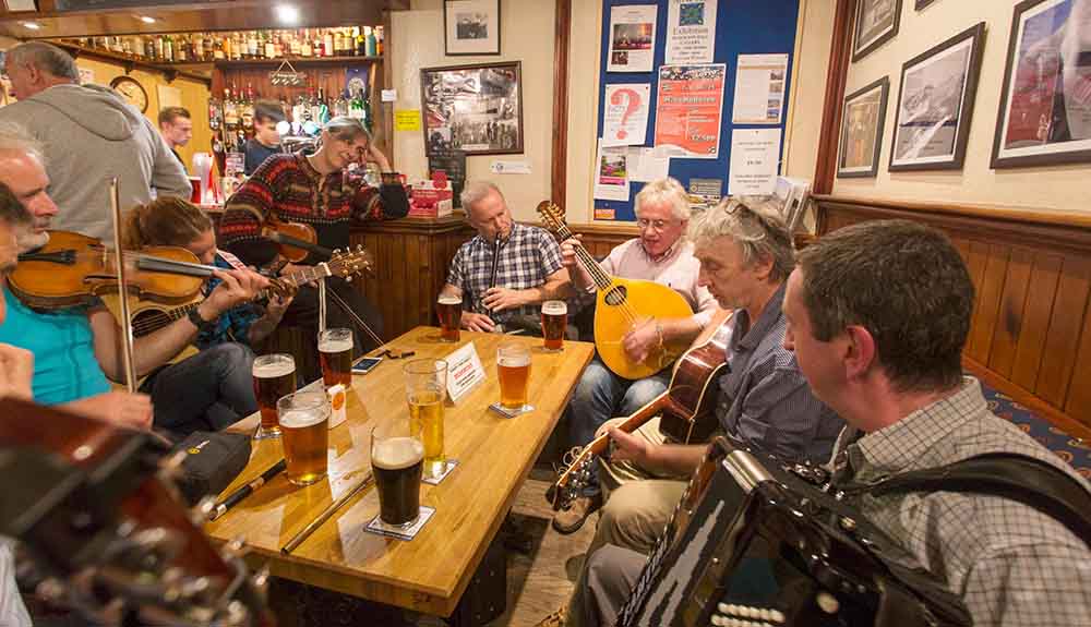 Local musicians play for a crowd at the Plockton Inn in Scotland