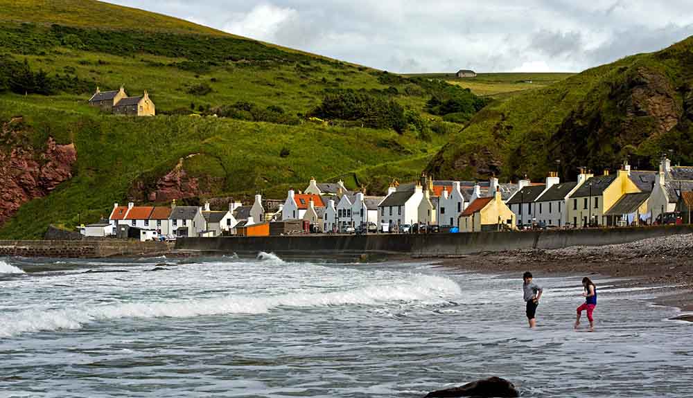 A few dozen fishing cottages line the shore in the village of Pennan, Scotland