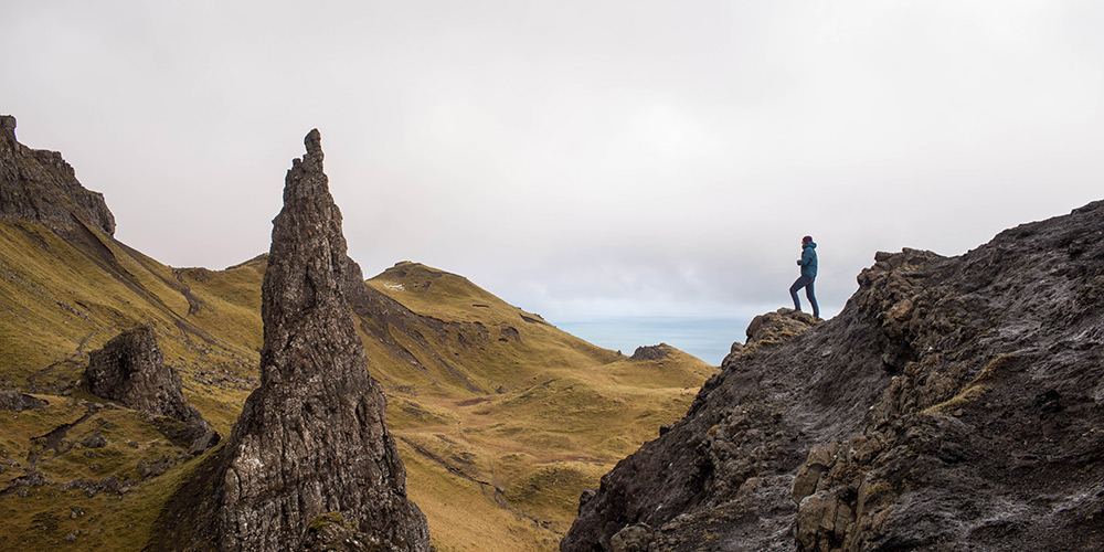Hiking along the craggy rocks in Portree, Scotland