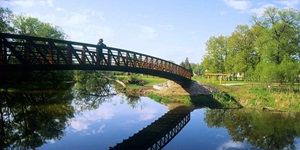 A pedestrian admires the view from a footbridge in the Kawarthas Northumerland region of Ontario.