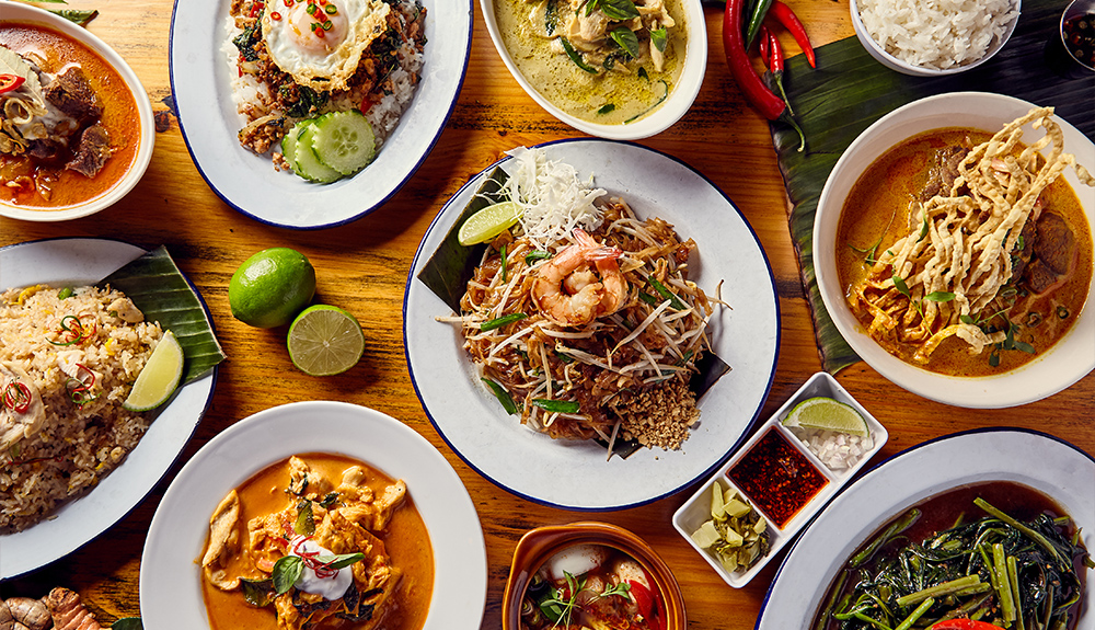 Several plates of Asian food.