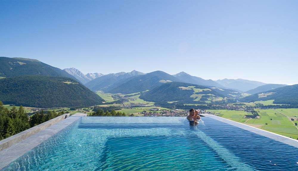 The infinity pool at the Alpin Panorama Hotel Hubertus in South Tyrol, Italy looks out at the Dolomite Mountains