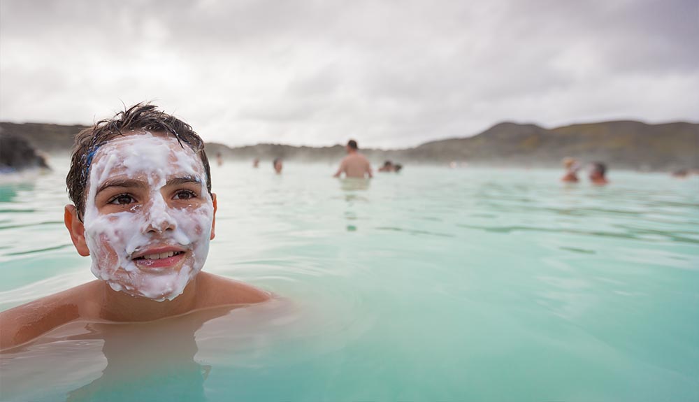 A boy swims in the Blue Lagoon in Iceland