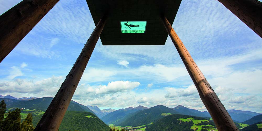 A view from below of the infinity pool on stilts at the Alpin Panorama Hotel Hubertus in South Tyrol, Italy