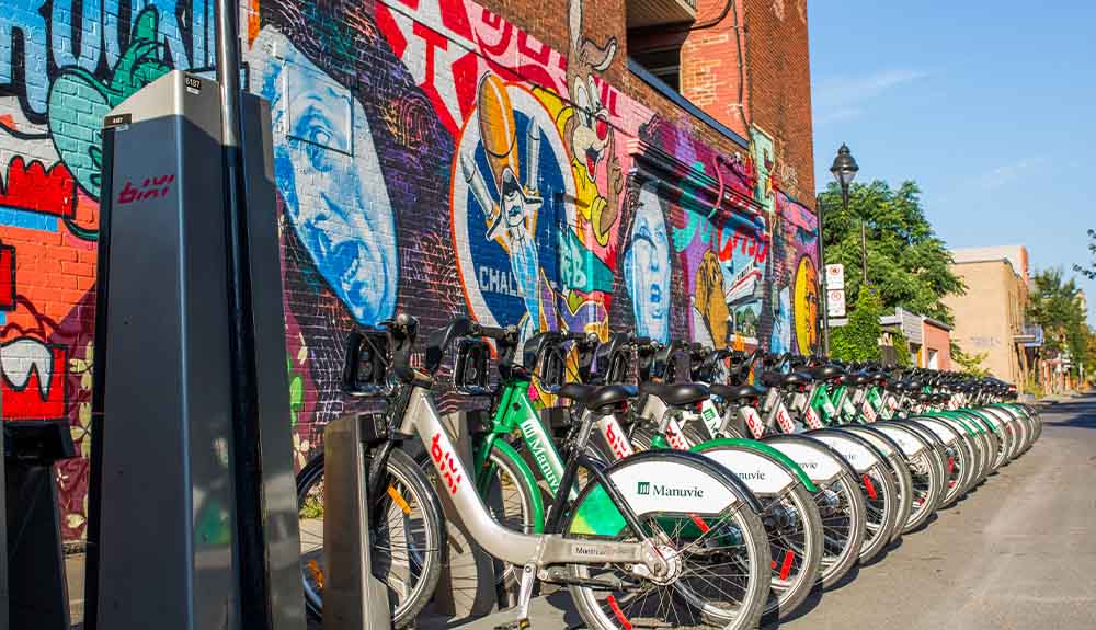 A row of Bixi bikes are secured on a side street in Montreal, Quebec