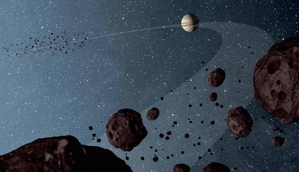 A planet is shown in space with large rocks in the foreground