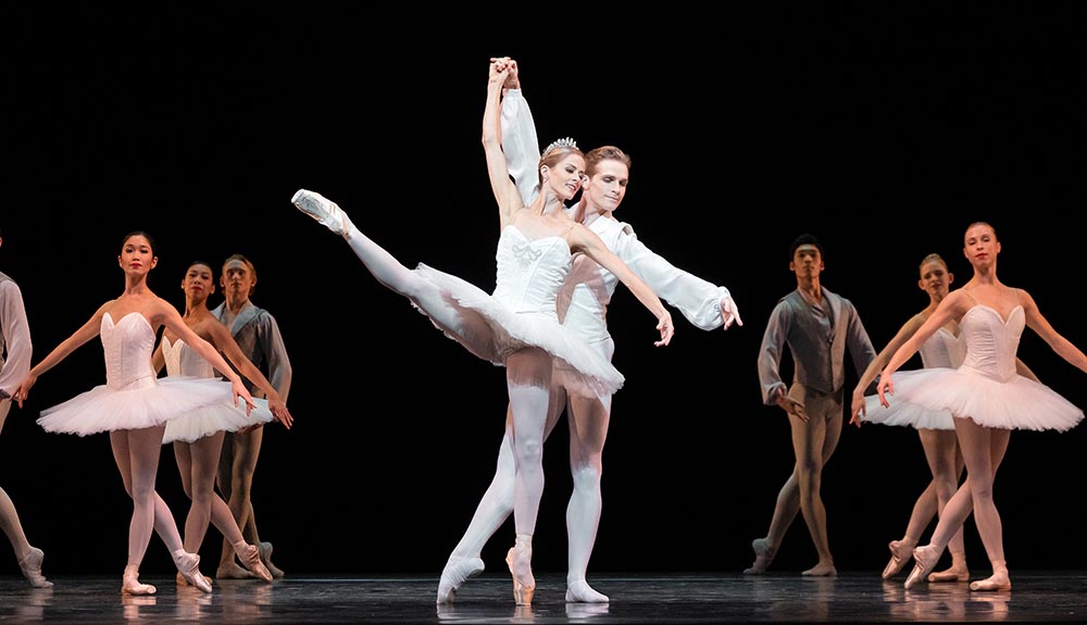 Ballet dancers are shown on a stage