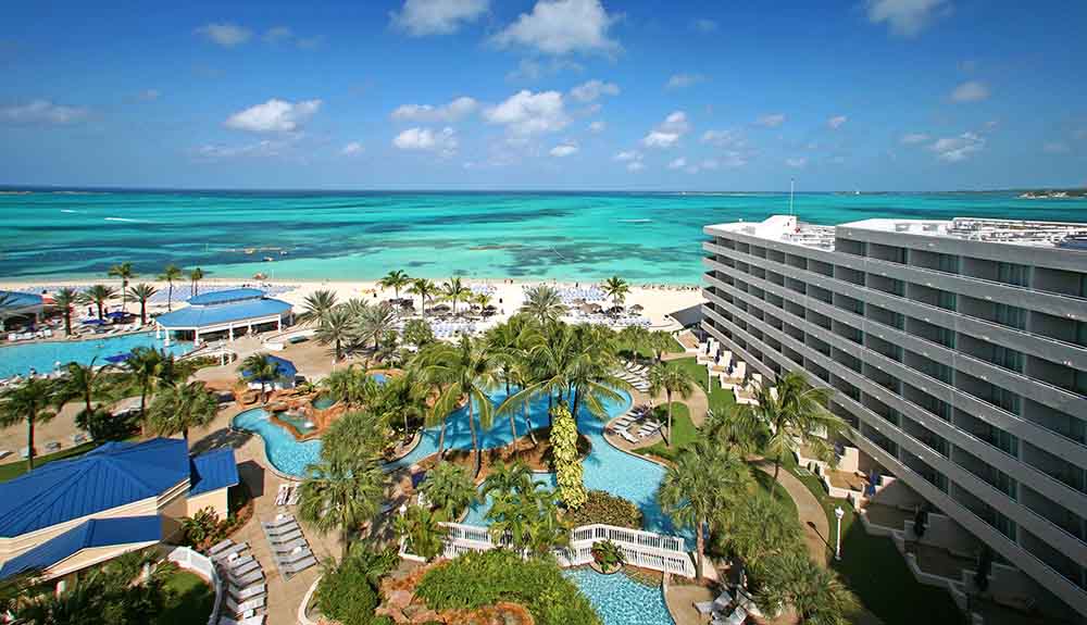 Aerial view of of the Melia Nassau Beach resort featuring the ocean and water pools