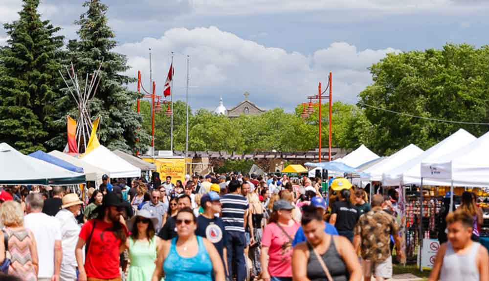 A crowd mills about the booths at Toronto's Annual Traditional Pow Wow event