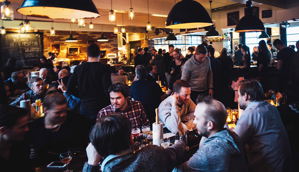 The busy gastro pub at the Kex Hostel is seen, every seat in the house taken by lively visitors