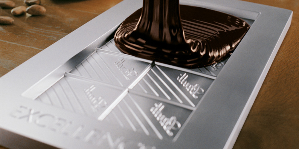 Dark chocolate is poured into a Lindtt Excellence mould