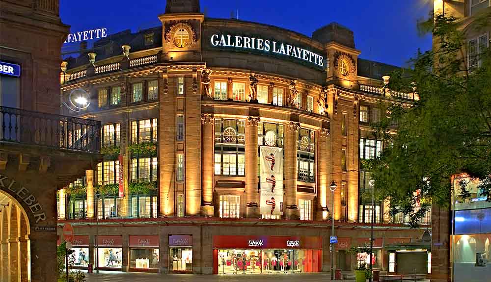 A street view of the Galeries Lafayette department store in Strasbourg at night