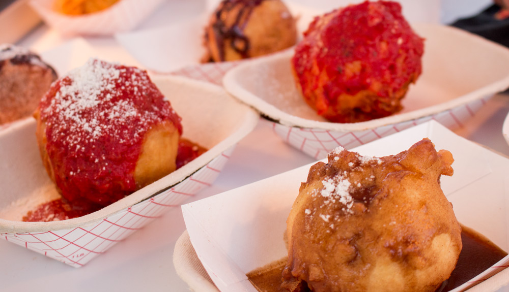 Spaghetti donut balls topped with red sauce an sprinkled with a hit of parmesan cheese seen at the CNE