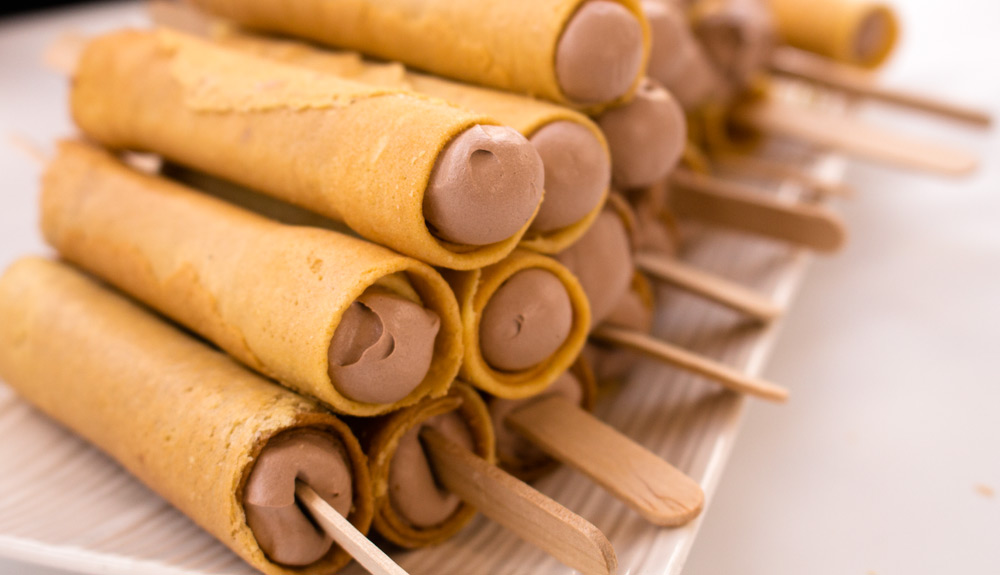 A fried golden crepe wrapped around chocolate ice cream on a stick, as seen at the CNE