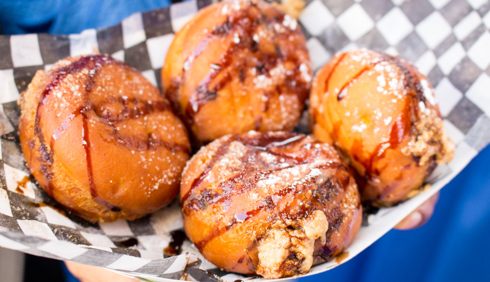Deep fried morsels with peanut butter oozing out that are drizzled with chocolate and Sriracha sauce, as seen at the CNE
