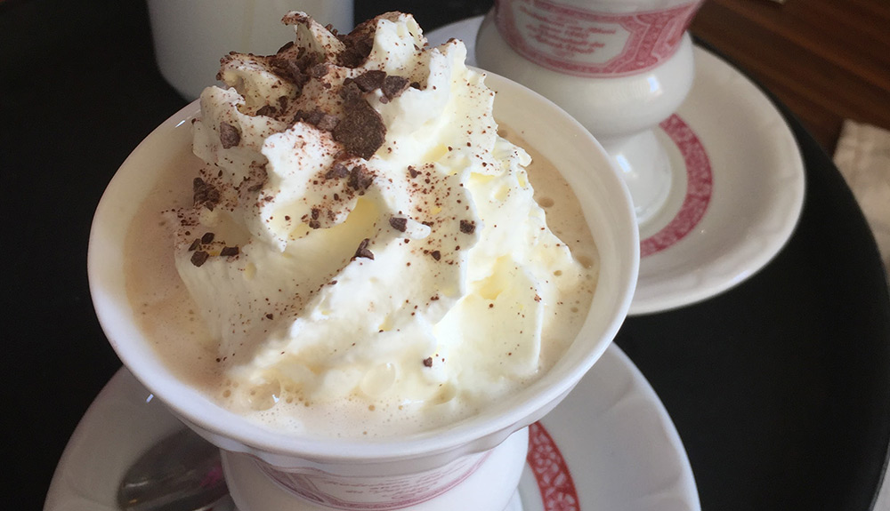 Hot cup of Rudesheimer kaffee with whipped cream on top