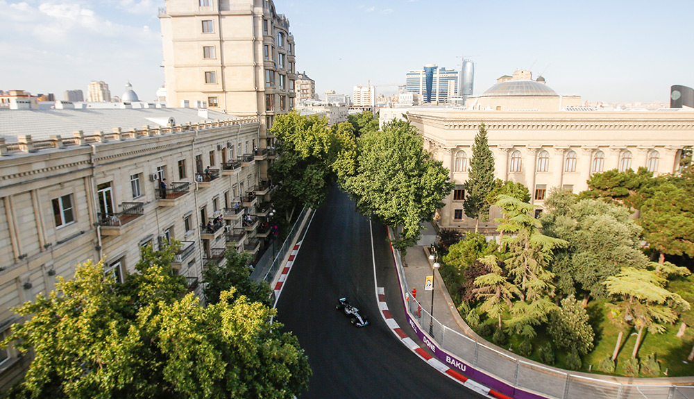 An overhead shot shows the Formula 1 race track nestled between trees and beautiful architecture in Baku, Azerbaijan