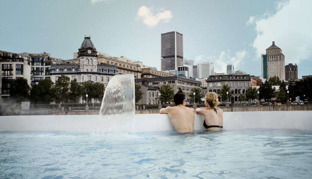 Man and woman hang over the edge of a pool at Bota Bota