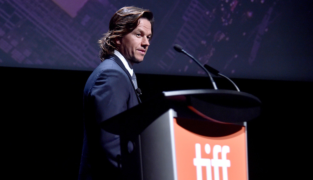 Mark Wahlberg prepares to speak at the podium at TIFF