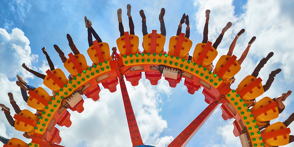 People strapped into a rollercoaster with their feet up in the air as the ride turns them upside down in Florida