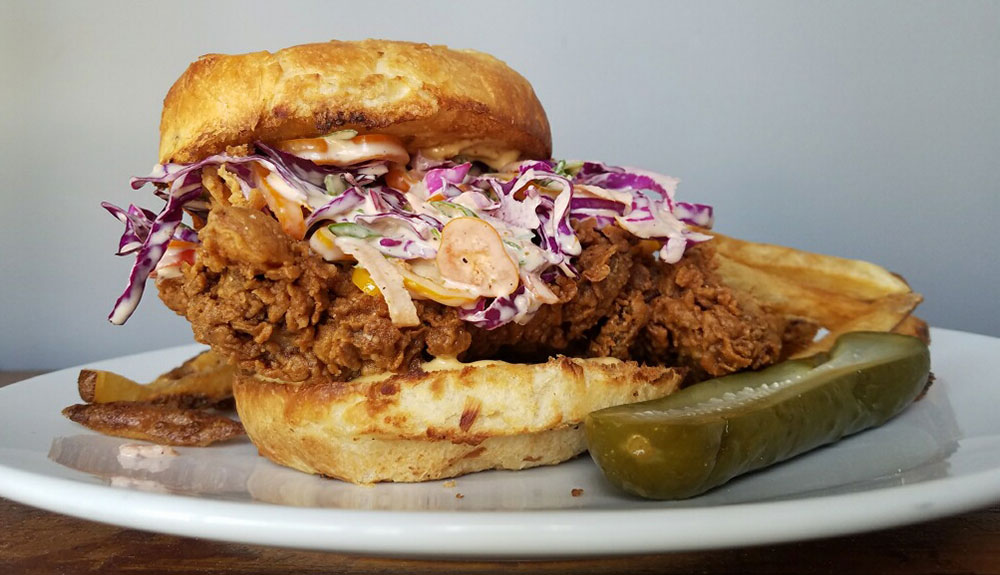 Delicious fried chicken sandwich with pickle on the side