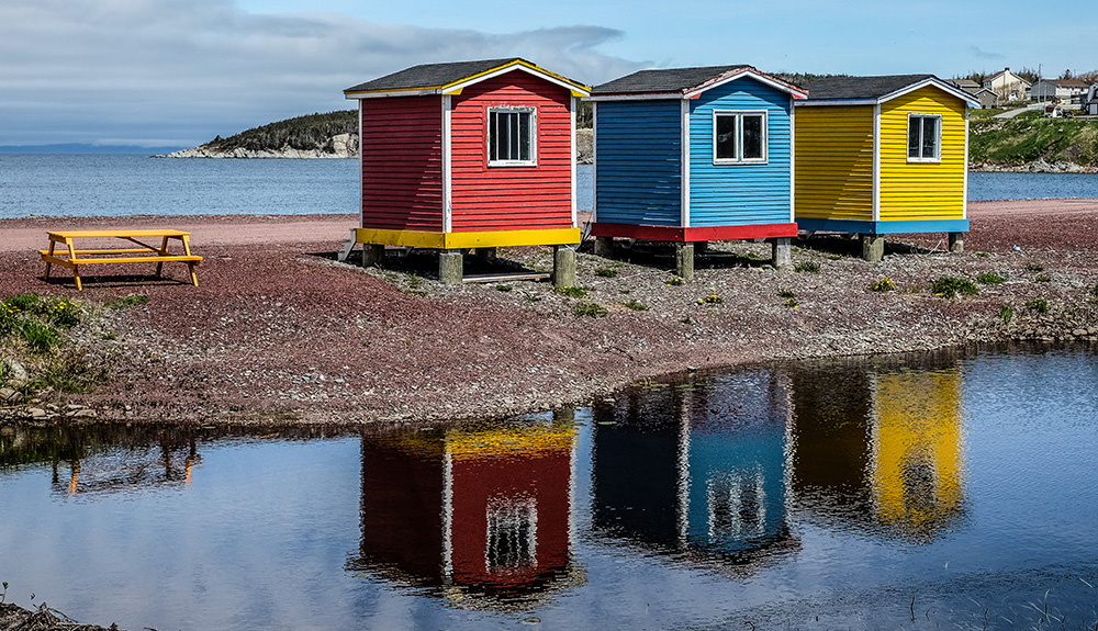 Photo submitted by Kabir Shaal of three colourful beach cabins by the shores in Cavendish, Newfoundland