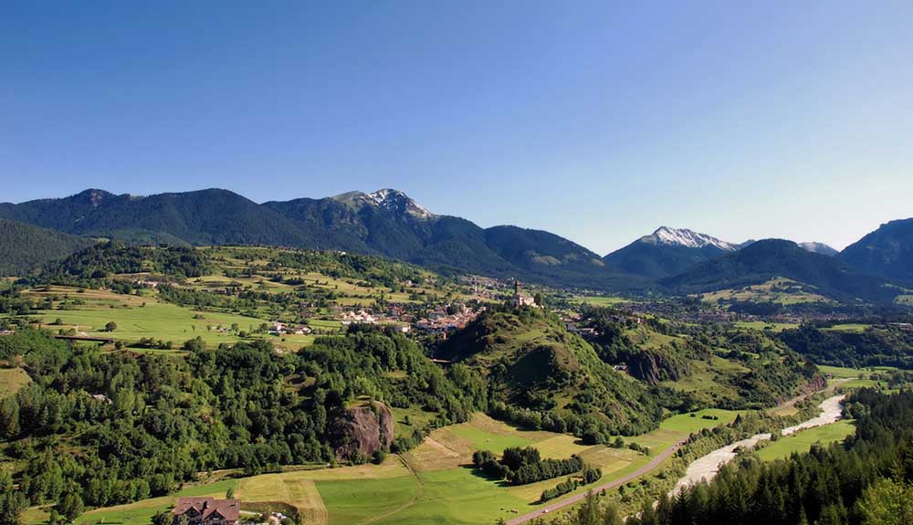 Beautiful view of grassy fields with the Italian Alps in the background