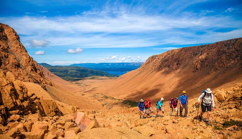Group of hikers exploring the Tablelands in Gros Morne National Park
