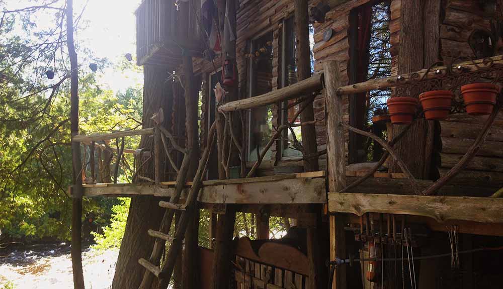 A wooden, multi-level tree house right in the forest in Lanark, Ontario