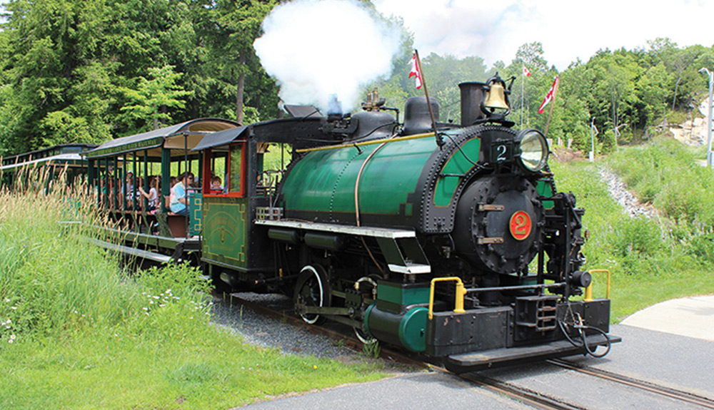 The green steam engine at the Muskoka Heritage Place trudges along with full cars of tourists enjoying the ride