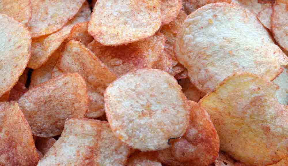 A close up of a pile of ketchup chips.