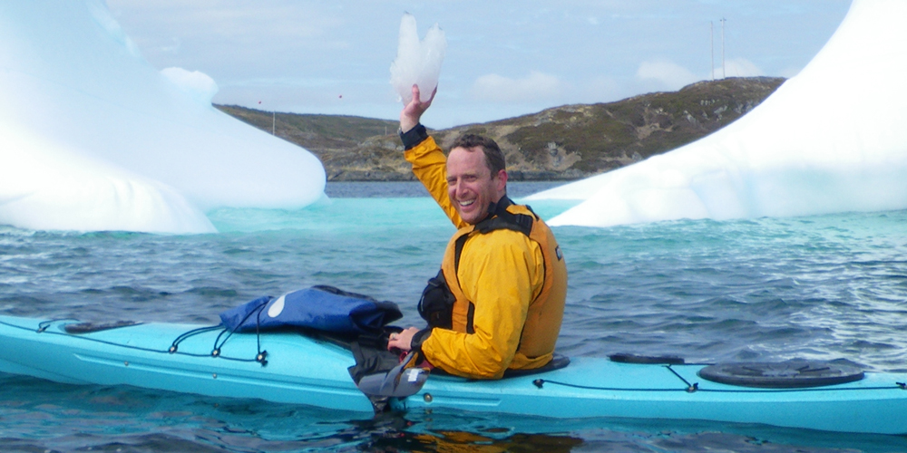 Robin Esrock kayaking with icebergs