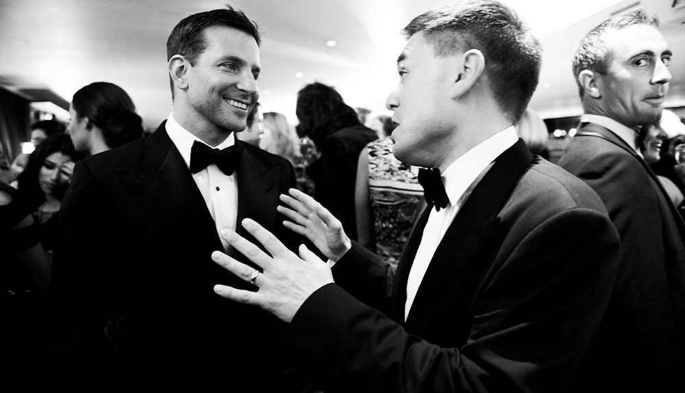 Comedian James Mullinger chatting to Bradley Cooper at a British GQ party
