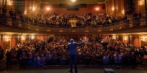 Comedian James Mullinger on stage in front of a packed house at the Imperial Theatre in Saint John, New Brunswick