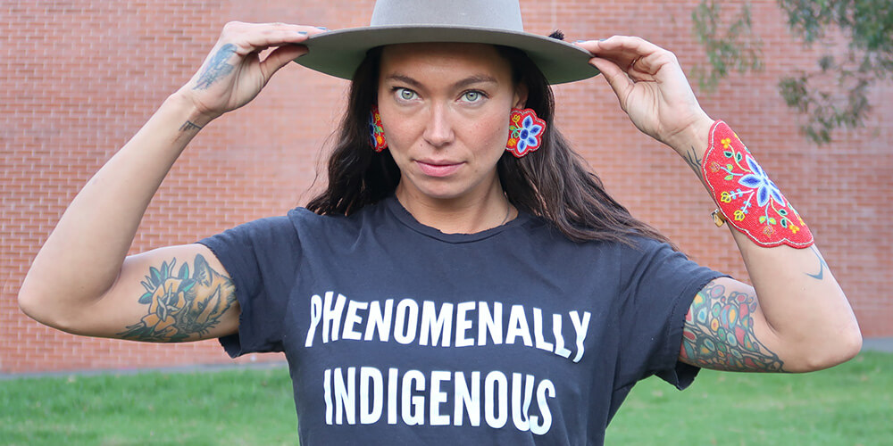 Sarain Fox wearing a t-shirt that says "Phenomenally Indegenous"