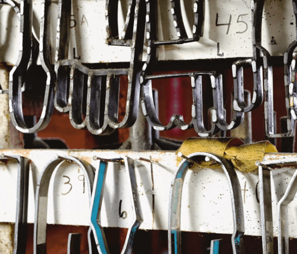 A red wall with glove-shaped cutting templates hanging on it.