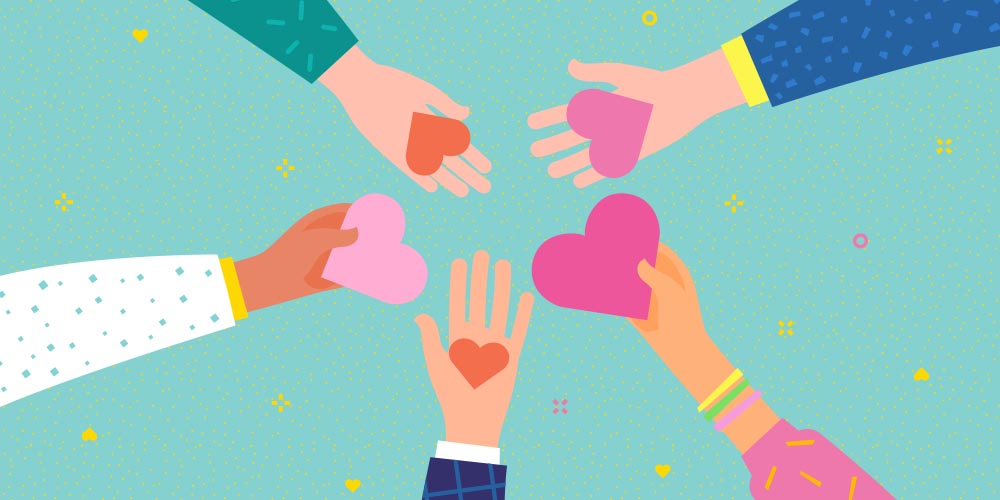 Five cartoon hands reach in together in a circle, holding various sized hearts in light pink, pink, orange and red. The arms and sleeves of the people are shown. Clockwise from the left, you see a white sleeve with small blue diamonds and a yellow cuff, a green sleeve with light green dashes, a blue sleeve with light blue dashes and a yellow cuff, a pink sleeve with yellow dashes and three thin bracelets of yellow, green and pink, and a dark blue sleeve with a light blue checked pattern and white cuff. The background is turquoise with scattered small yellow hearts, stars and circles.
