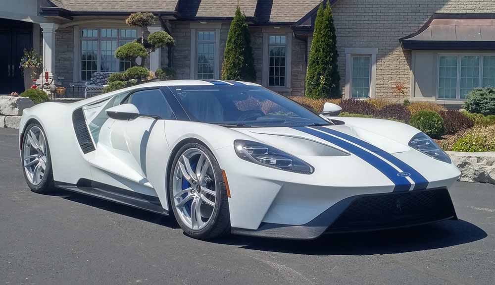 White 2018 Ford GT sport scar parked outside residential home