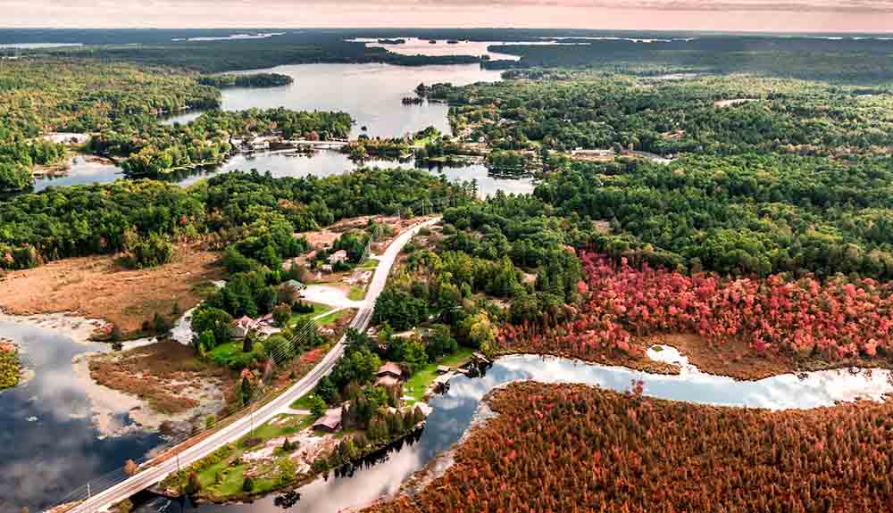Aerial view of highway winding between lakes in Kawarthas Northumberland