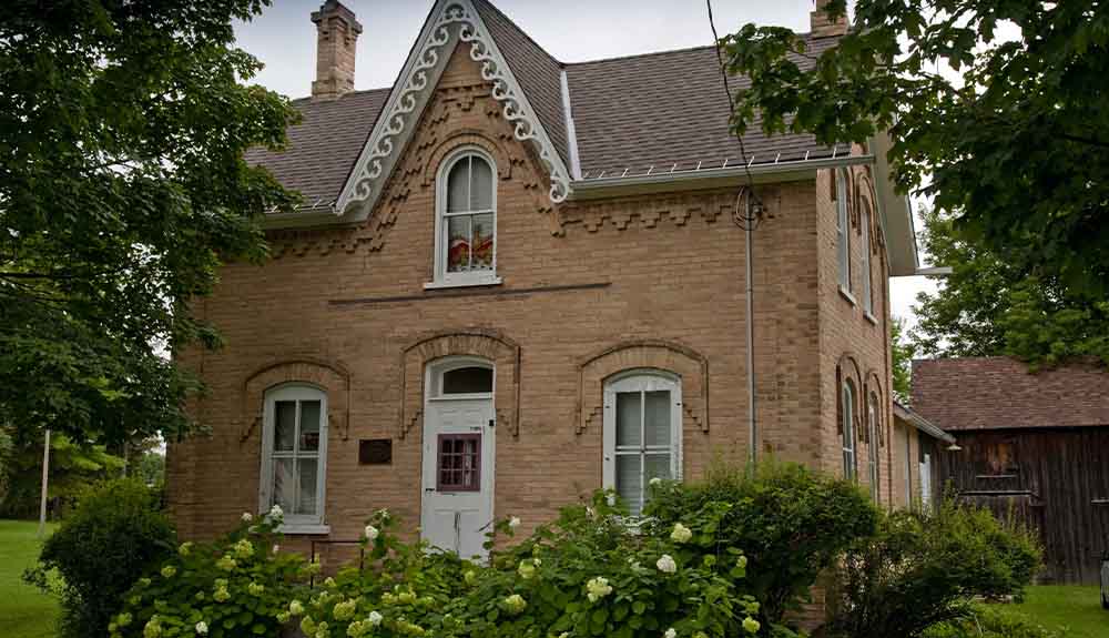 An older brick home in Neustadt, Ontario is shown