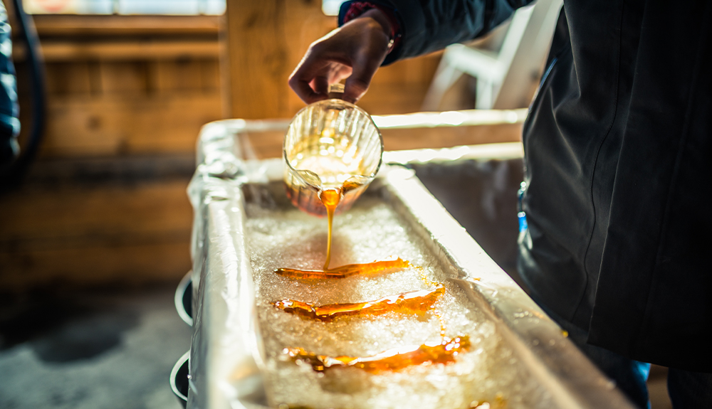 Strips of maple syrup are poured over shaved ice to make taffy.