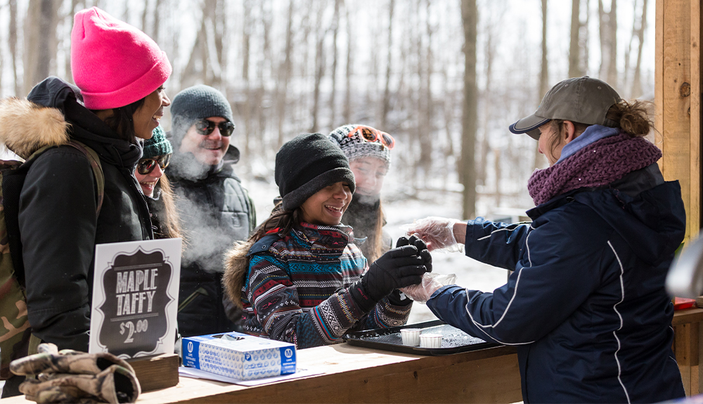 People paying for maple syrup
