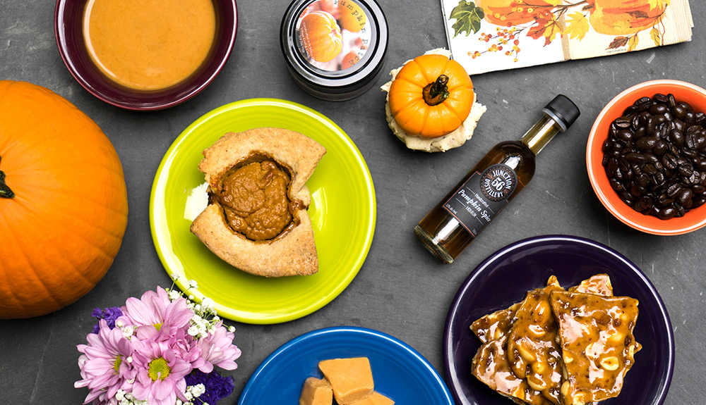 Tablescape with pumpkin pie, pumpkins, pumpkin syrup and candy brittle