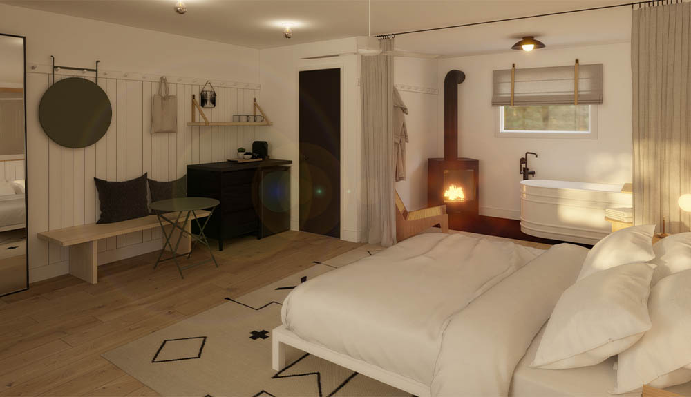 An off-white room with white panelled-walls. There is a large bed made with white bedding and four pills. Behind it there is a white bathtub with a window above it.
