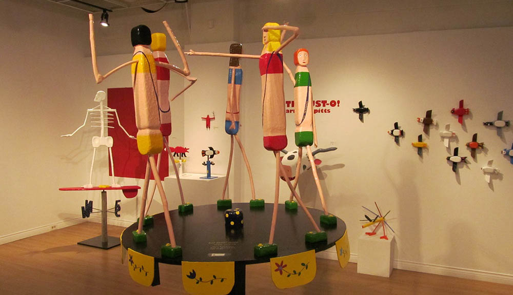 Barry Colpitts' sculptures standing in a circle on display at Colpitts Folk Art gallery