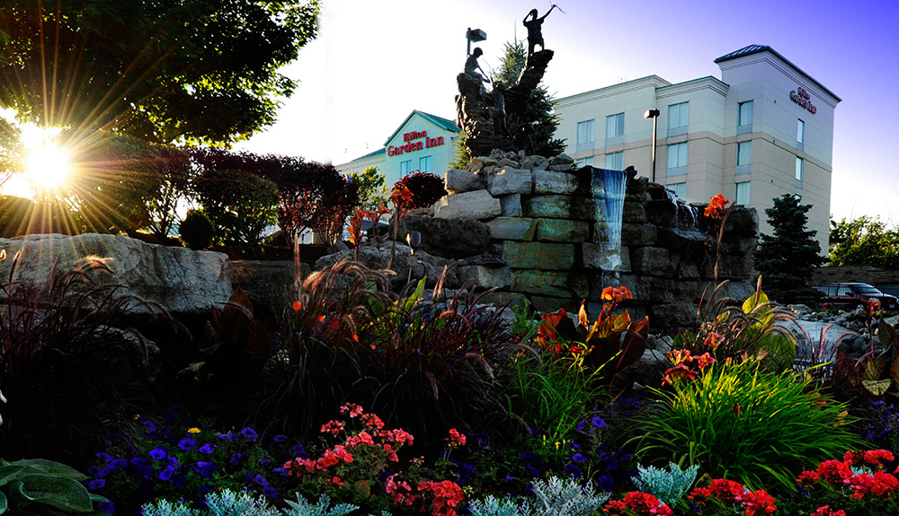 Beautiful side view of a garden featuring Hilton Garden Inn at the top